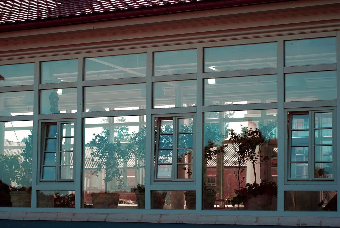 A home's wall of spotless, streak-free windows reflecting the garden